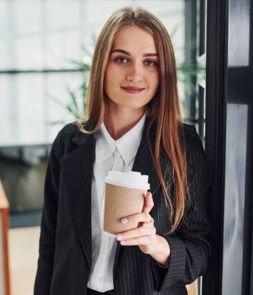 woman-in-formal-clothes-standing-indoors-in-the-of-RL3HSGC.jpg